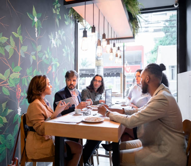 istock Multiracial business group discussing work during lunch at a coffee shop 1468653289