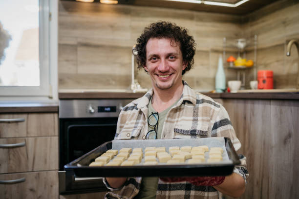 istock Young man cooking in the kitchen 1468654265