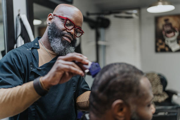 istock Stylish barber giving customer a hair cut 1468655042