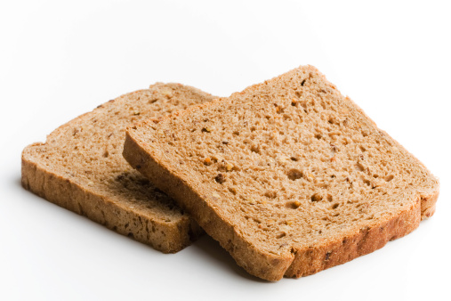 two brown bread loafs on white background