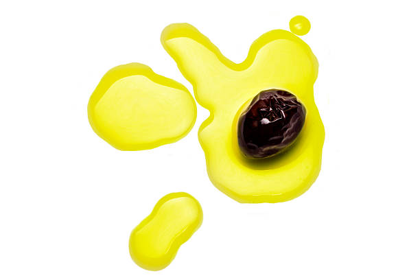 Black Olive on Splashed Oil Drops stock photo