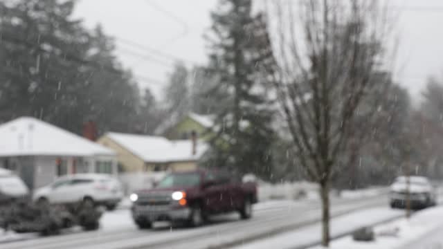 Defocused cars drive on a snowy road