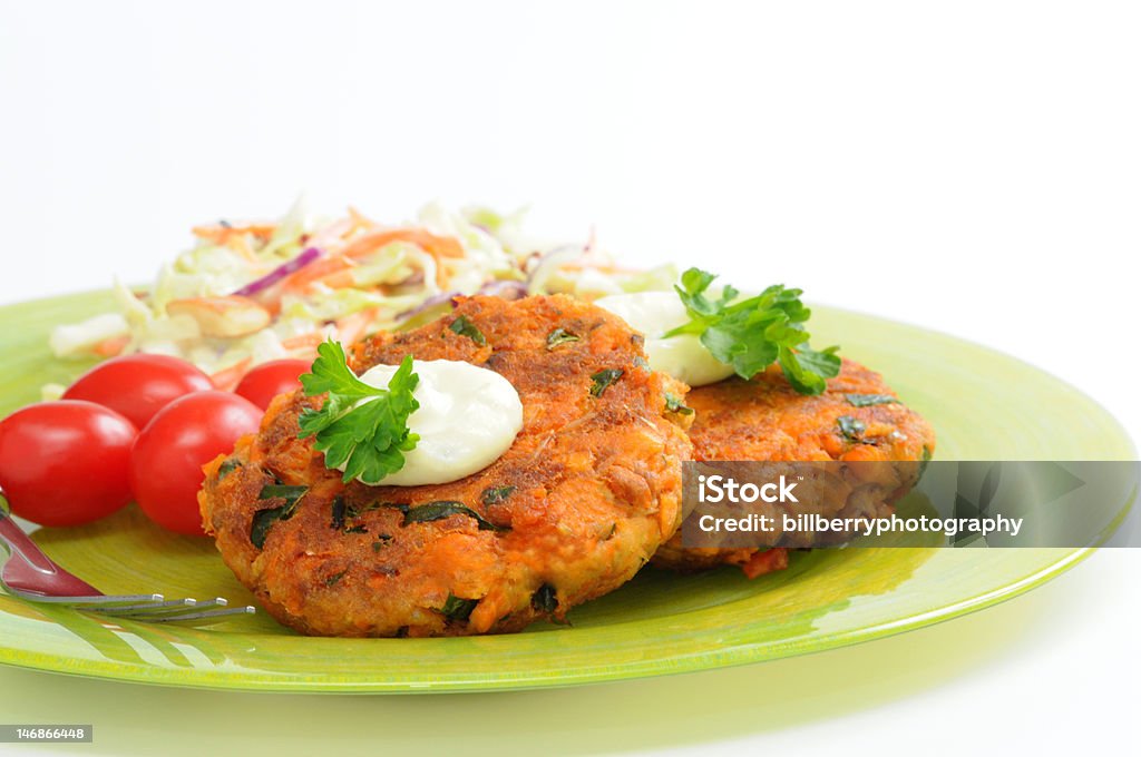 Salmon Burgers Tasty salmon burgers served with vegetables. Burger Stock Photo