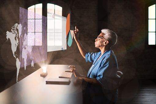 Senior woman working using an augmented reality device