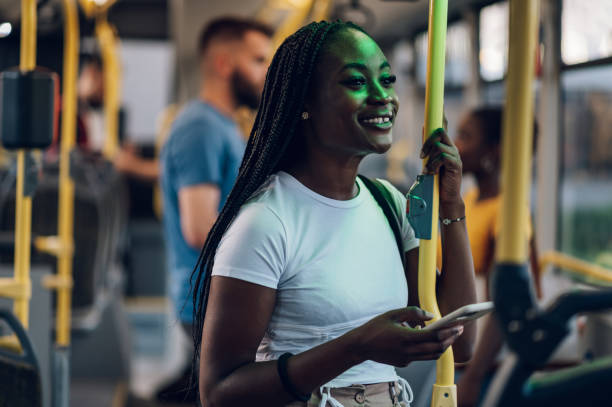 istock African american woman riding in a bus and using a smartphoneduring a night 1468670177