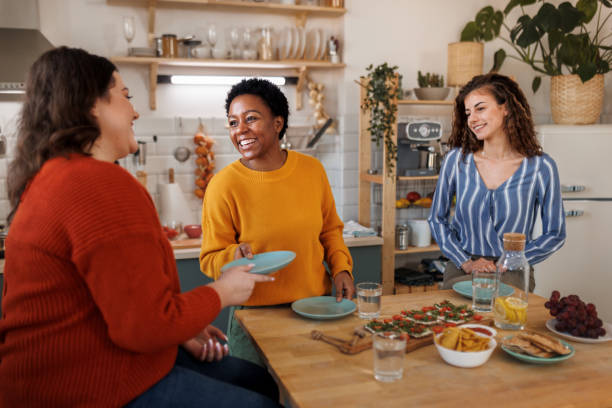 istock Female friends having good time while having brunch in the kitchen 1468670981