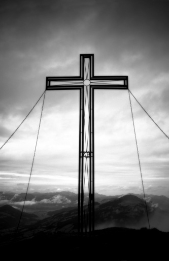 A cross on an Alpine mountain peak