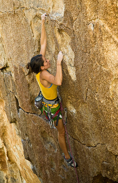 istock Female climber clinging to a cliff. 146867249