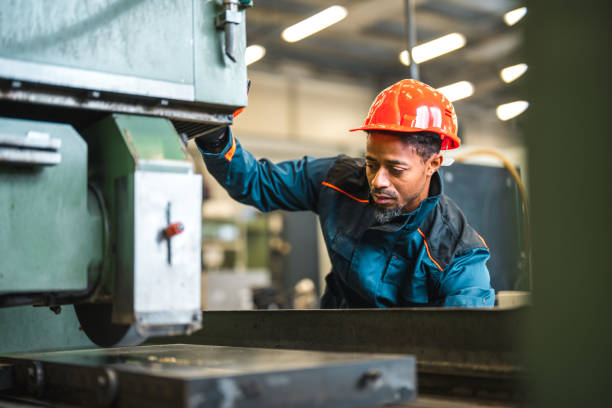istock Black Male Factory Worker Operating An Industrial Machine 1468676800