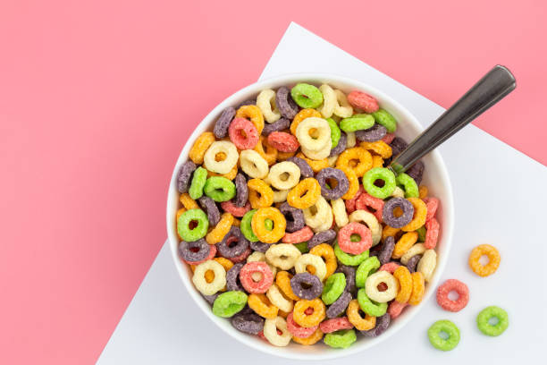 istock Colored breakfast cereal in a bowl on a pink background, flat lay. 1468678255