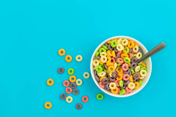 istock Colorful cereal in white bowl with spoon on a blue background, flat lay. 1468678256