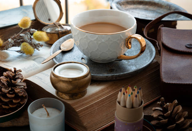istock Hot coffee in ceramic cup and brass coffee spoon served with Fresh milk on worktable. 1468678342