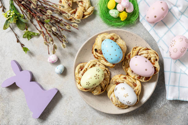 istock Easter composition. Sweet Italian Easter Bread Rings from puff pastry and dyed eggs on a stone background. View from above. 1468678486