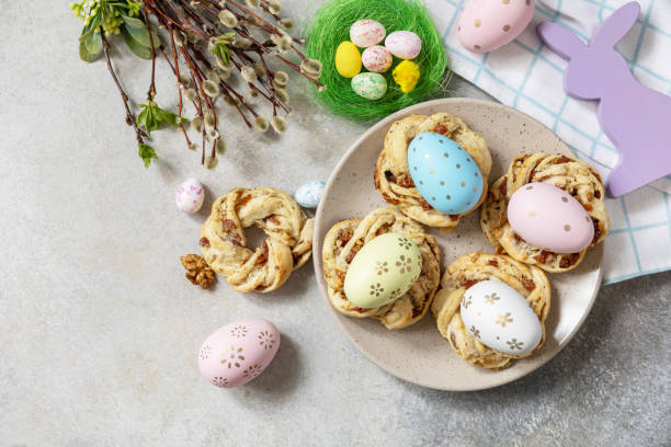 istock Easter composition. Sweet Italian Easter Bread Rings from puff pastry and dyed eggs on a stone background. View from above. Copy space. 1468678487