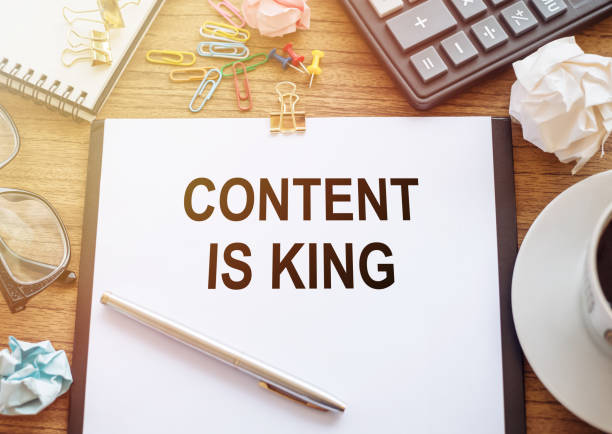 istock Office paper with text Content Is King andoffice tools on wooden table for background 1468678579
