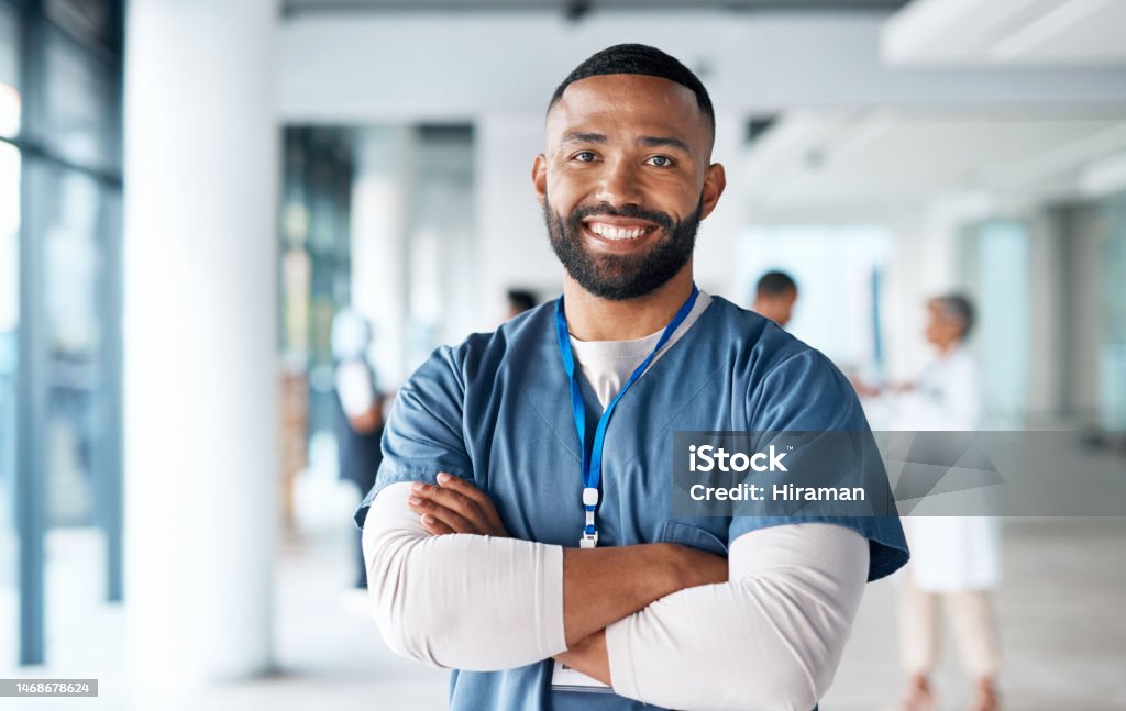 Nurse, hospital employee and portrait of black man in a healthcare, wellness and clinic feeling proud. Happy, smile and doctor in a medical facility with happiness from workplace vision and success Nurse Stock Photo