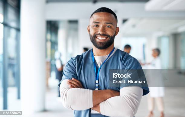 Nurse Hospital Employee And Portrait Of Black Man In A Healthcare Wellness And Clinic Feeling Proud Happy Smile And Doctor In A Medical Facility With Happiness From Workplace Vision And Success Stock Photo - Download Image Now