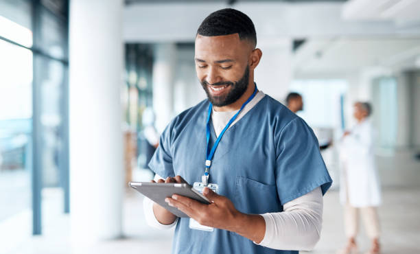 Healthcare, doctor and black man with tablet for telehealth, research and consulting patient online. Hospital, insurance and male with digital tech for medical report, data analysis and wellness app stock photo