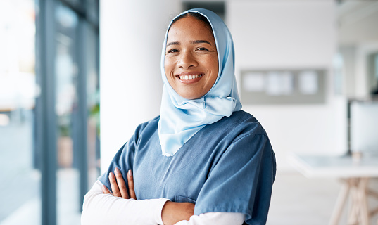 Medical, happy and smile with portrait of nurse for wellness, healthcare and innovation in hospital. Goals, vision and medicine with muslim woman and arms crossed for physician, expert and surgery