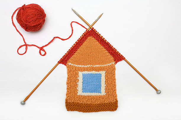 Knitted house on white background stock photo