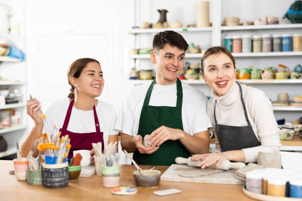 istock Joyous young man and women sculpting handmade cups 1468679357