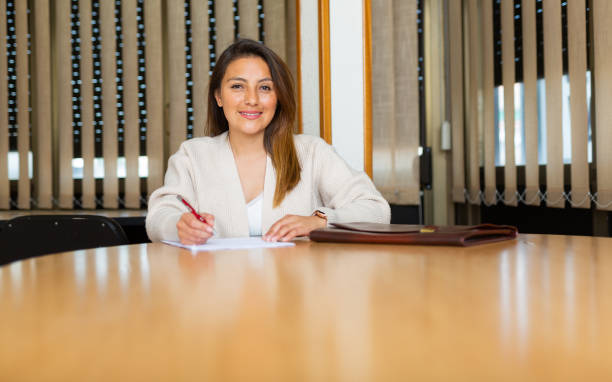 istock Smiling young hispanic business woman ready to sign documents 1468679433