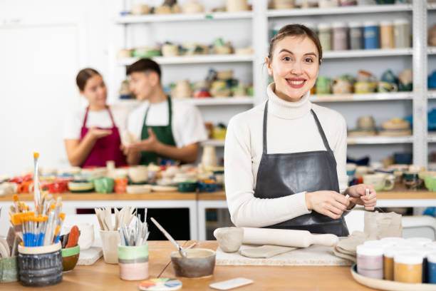 istock Young woman cutting row clay cup 1468679437