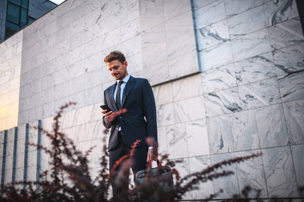 istock Young Caucasian Businessman Using A Smart Phone In A Financial District 1468679674