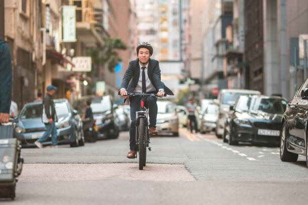istock Young Male Finance Intern Going To Work Using A Bicycle 1468679759