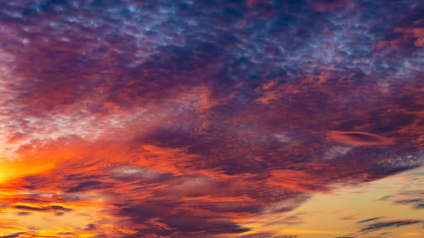 istock Sunset sky. Cirrocumulus and cirrostratus clouds during sunset. Beautiful dramatic sunset sky background. Selective focus included. 1468684047