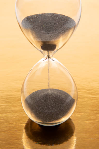 istock hourglass on a golden background. time and minute measurement 1468684708