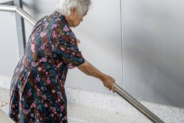 istock Asian senior or elderly old lady woman patient use handle at stairs security support in building, healthy strong medical concept. 1468684962