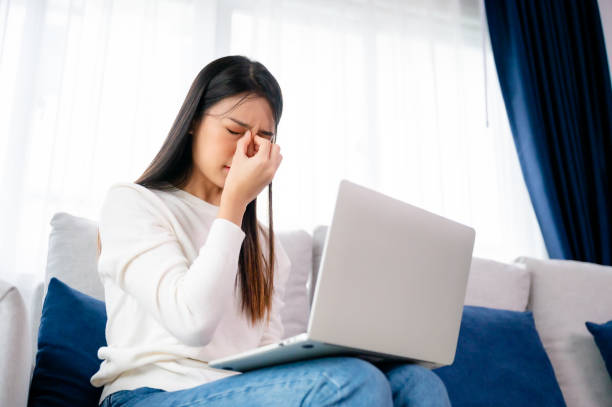 istock Office syndrome. Overworked tired young asian woman feeling headache, having eyesight problem after computer laptop work. Stressed young woman suffering from fatigue at home 1468687761