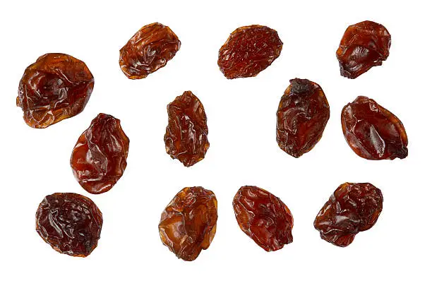 Photo of Several raisins isolated on white background