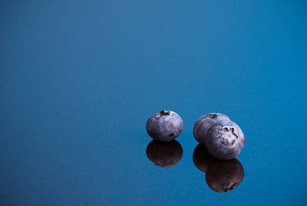 Blueberries on blue background stock photo