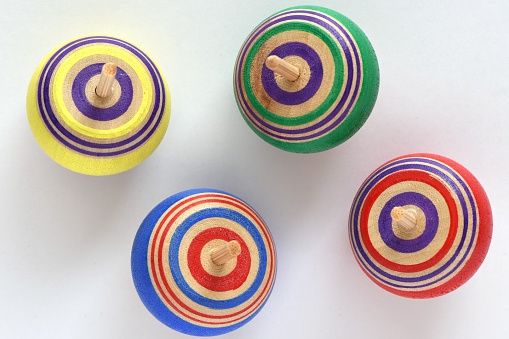 Spinning tops on white background.