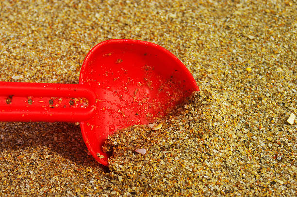 Red Shovel in the Sand stock photo