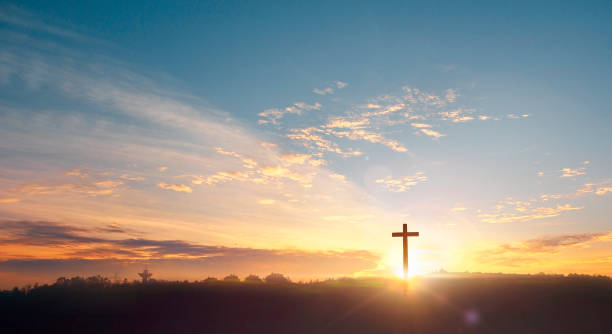 istock Cross of Christ Jesus on sunset background 1468716225