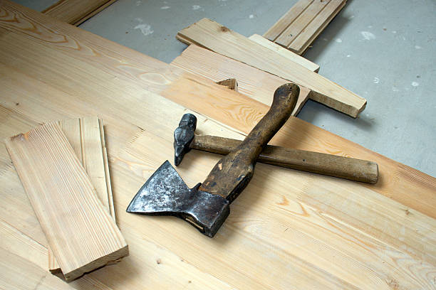 Hammer and axe on wooden to a floor stock photo
