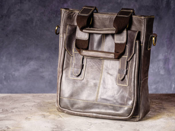 istock Brown leather business everyday bag with handles on concrete background 1468722986