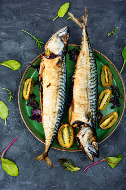 Grilled mackerel fish with kiwi stock photo