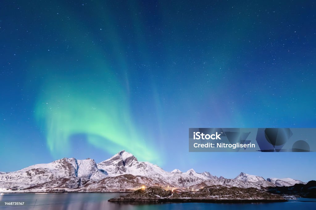 Northern Lights in winter landscape Northern lights dancing in the sky of Lofoten Islands, Norway Astronomy Stock Photo