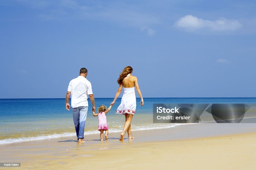 family on shore view of young family having fun on the beach Activity Stock Photo