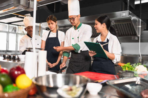 istock Asia chef teaching Asia woman assistant chef cooking at kitchen background 1468739200