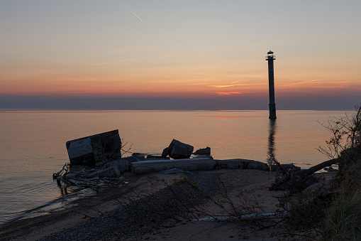 Kiipsaare lighthouse in Saaremaa, Estonia. Iconic local landmark - skew abandoned lighthouse. Sunset with a red colored sky.