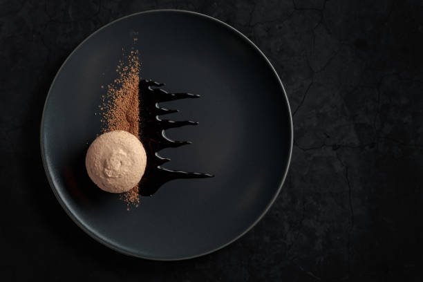 istock Macaroon on a black plate garnished with chocolate sauce and cocoa powder. 1468740648