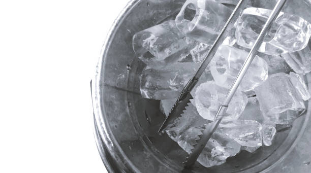 Ice cube in ice bucket on white background stock photo