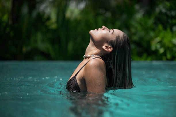 istock Young beautiful woman in swimming pool. 1468742638