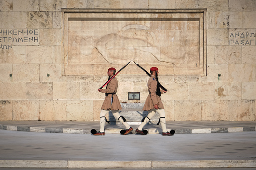 Athens, Greece - May 14, 2019. Ceremony of Presidential guard Evzones by the Greek tomb of Unknown Soldier. Evzones in summer uniform walk away from each other. Close shot.