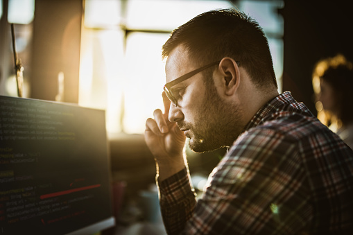 Concentrated Programmer Reading Codes On Desktop Pc In The Office Stock ...